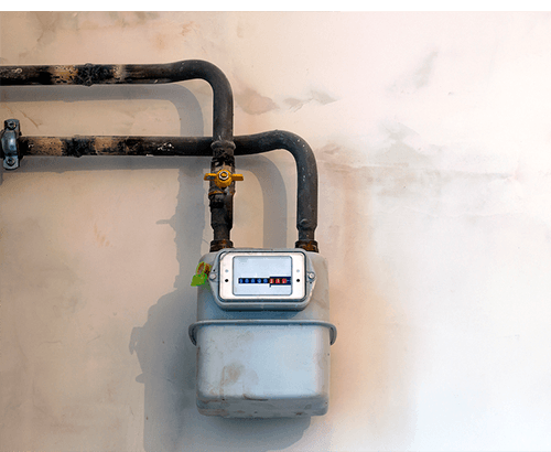 Gas meter on house with gas pipes